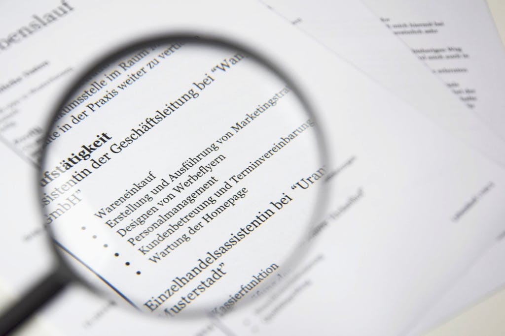 Close-up of a business document text under a magnifying glass.